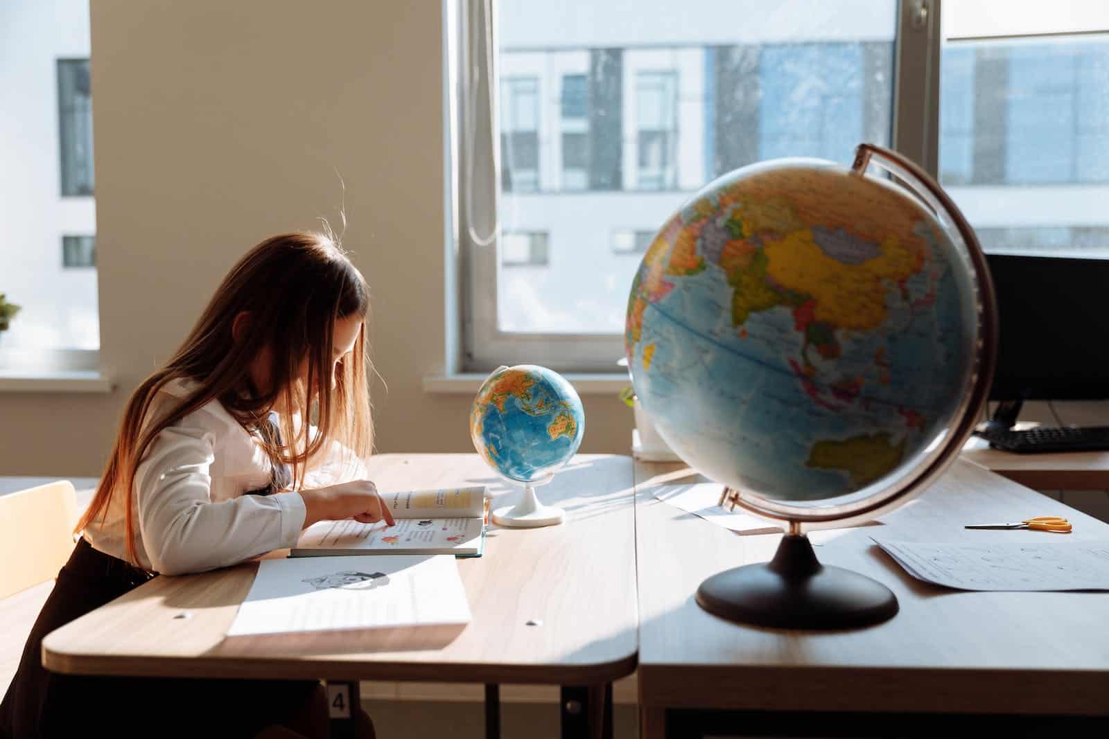 Side View of a Student Studying about Geography